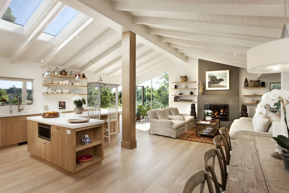 Modern kitchen with white cabinets, a large island, pendant lights, and wooden accents.