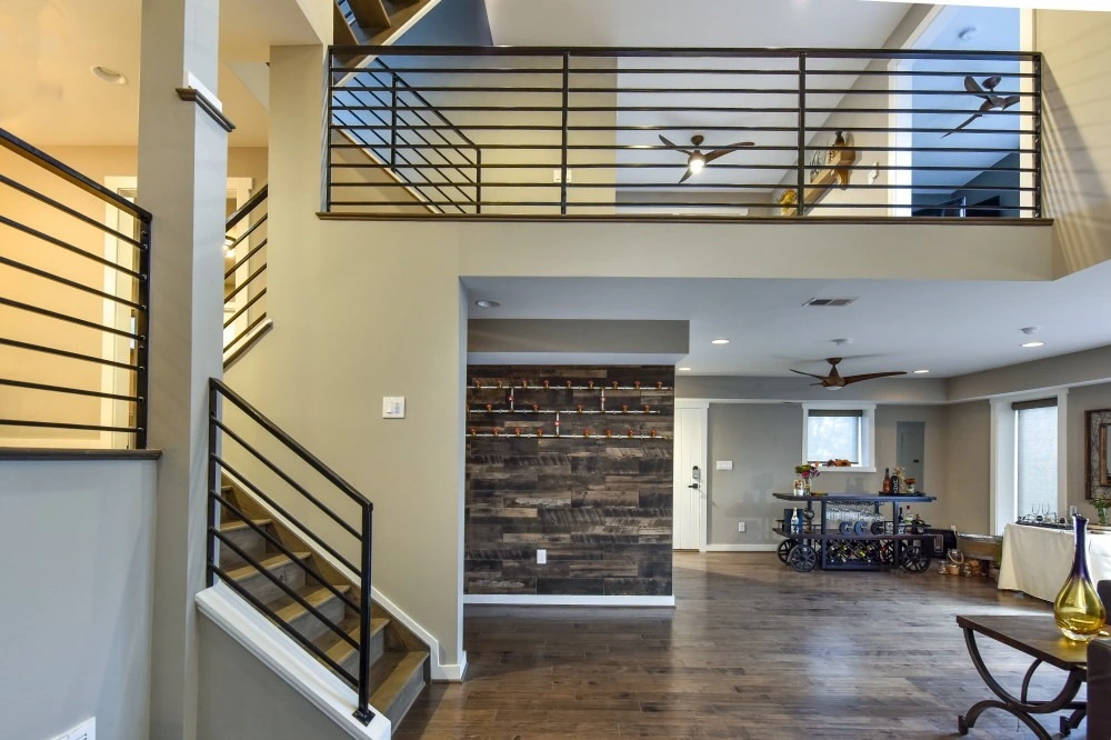 Modern kitchen with white cabinets, a large island, pendant lights, and wooden accents.