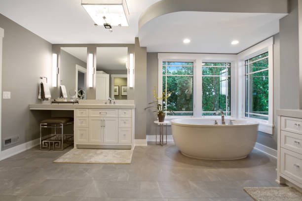 Modern kitchen with white cabinets, a large island, pendant lights, and wooden accents.