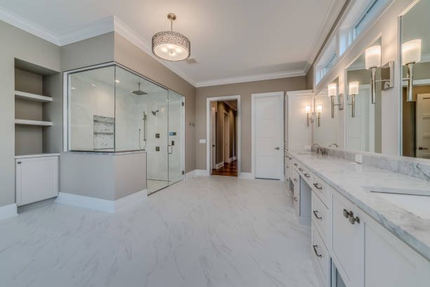 Modern kitchen with white cabinets, a large island, pendant lights, and wooden accents.