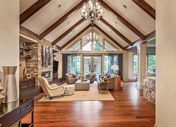 Modern kitchen with white cabinets, a large island, pendant lights, and wooden accents.