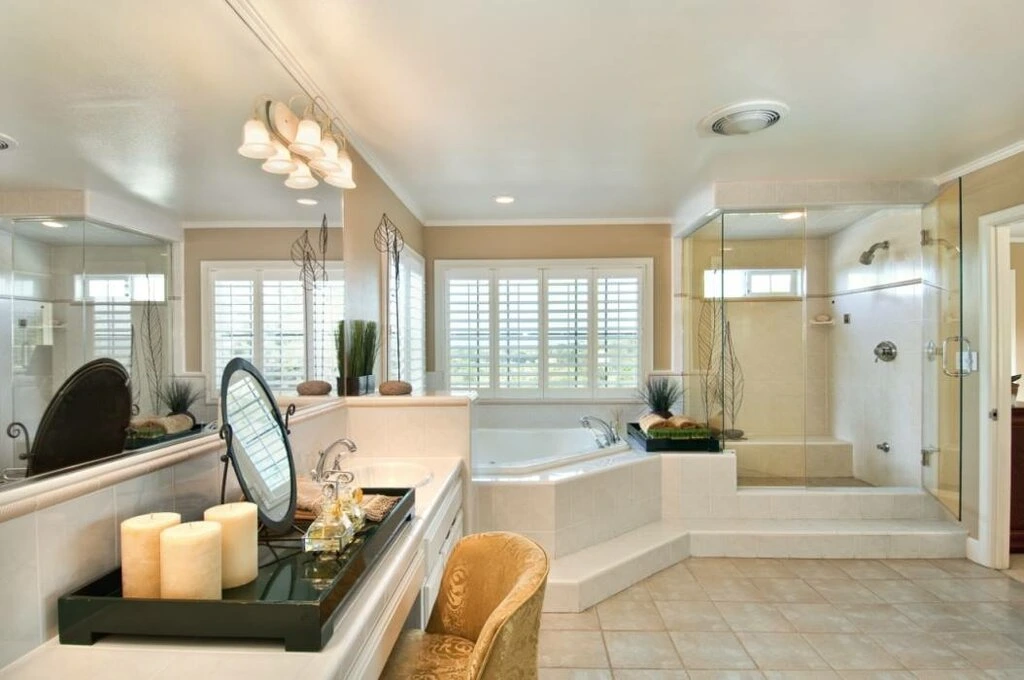 Modern kitchen with white cabinets, a large island, pendant lights, and wooden accents.
