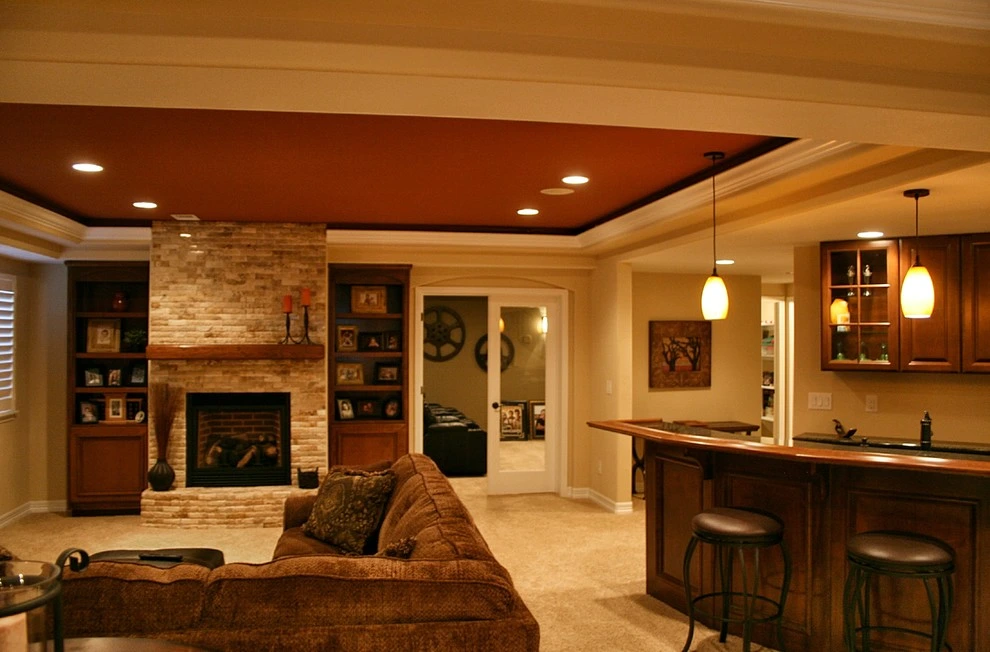 Modern kitchen with white cabinets, a large island, pendant lights, and wooden accents.