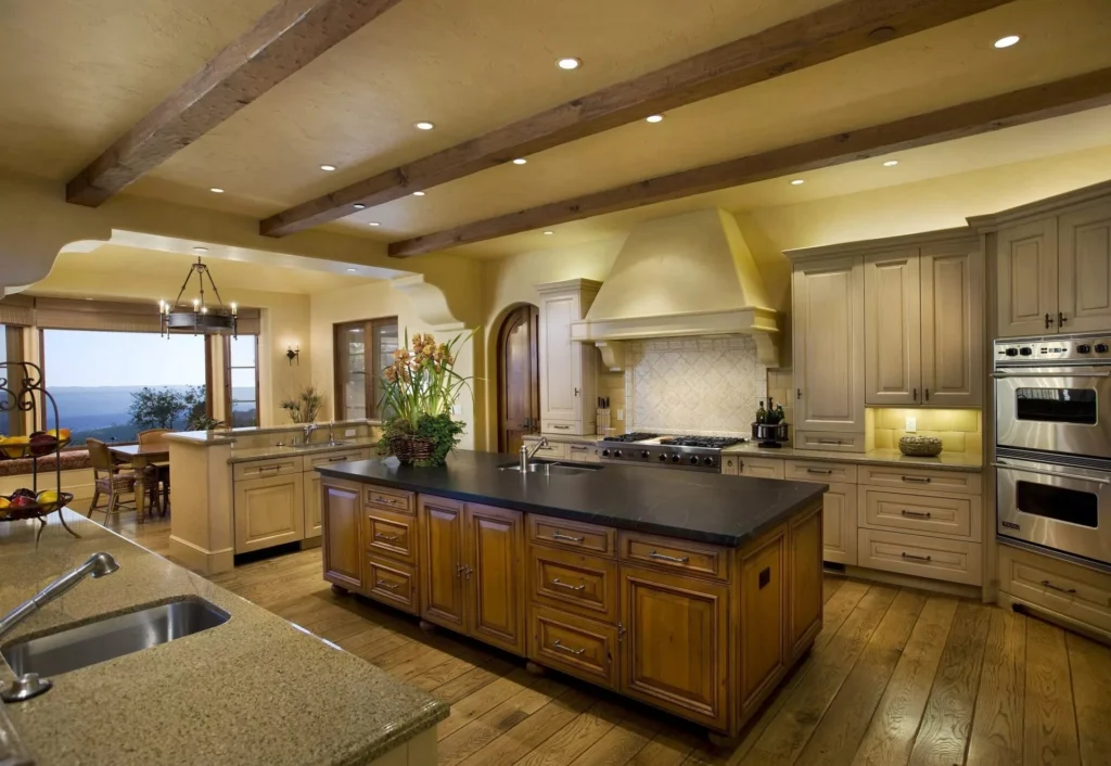 Modern kitchen with white cabinets, a large island, pendant lights, and wooden accents.