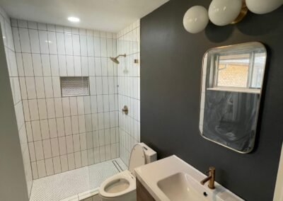 Bathroom Remodel with Vertical Tile Shower and Geometric Floor