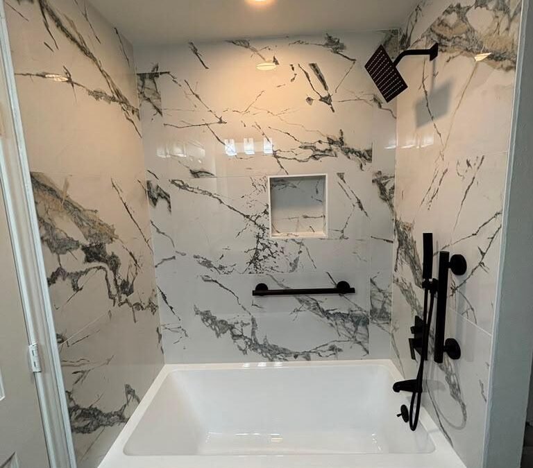 Bathroom Remodel with Marble-Look Tile, Matte Black Fixtures, and Sliding Glass Shower
