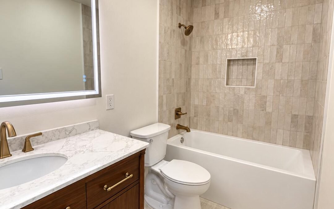 Bathroom Remodel with Walnut Vanity, Vertical Tile Tub Surround, and Brushed Brass Fixtures