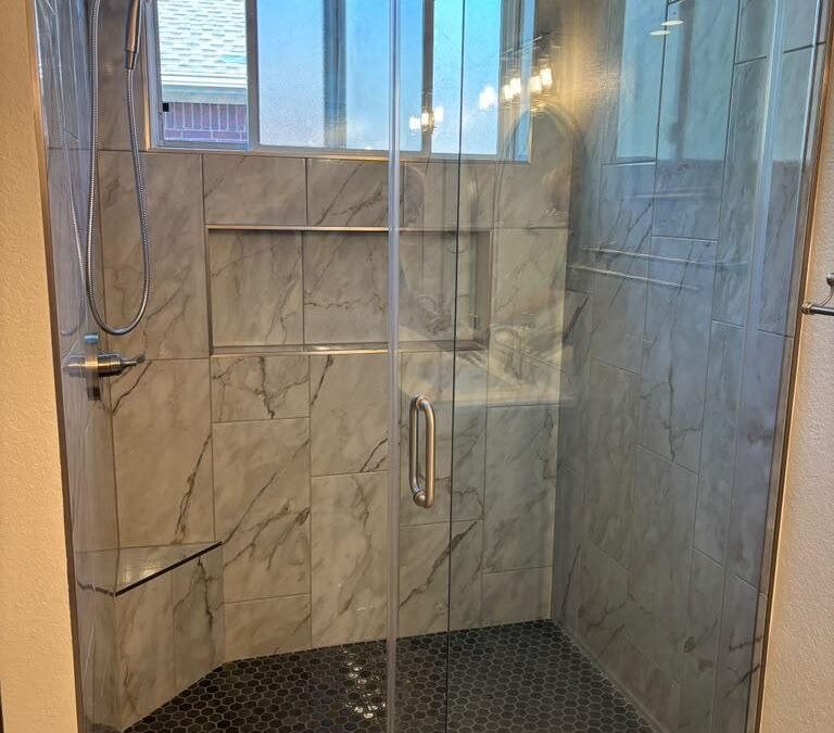 Walk-In Shower Remodel with Marble-Look Tile and Sliding Glass Door