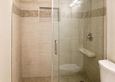 Tub-to-Walk-In Shower Conversion with Warm Neutral Tile and Sliding Glass Door